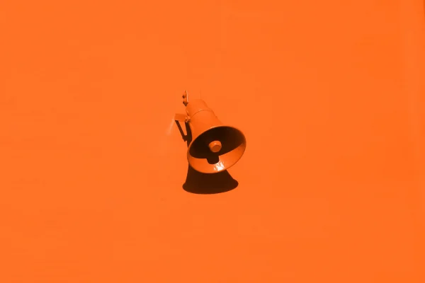 coming soon splash - orange wall with a megaphone